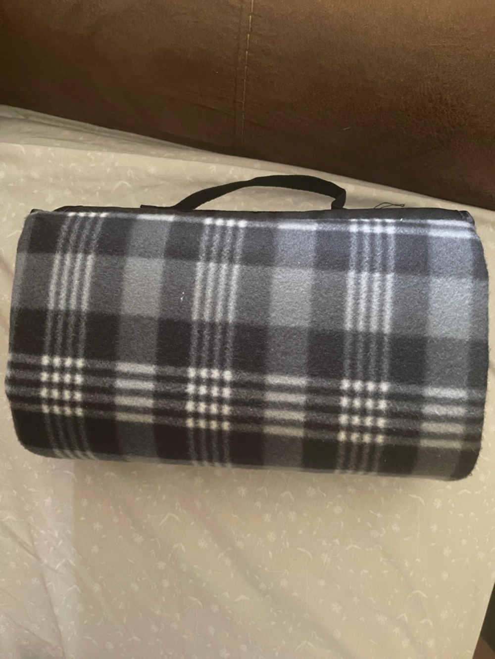 Gray & Black plaided blanket. Can be used in or outdoors . Good for traveling.